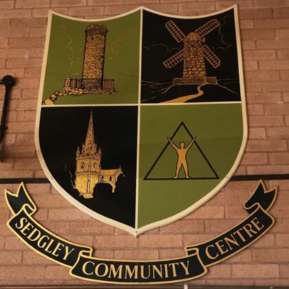 Community Association Shield designed by Kathryn Deakin in 1985